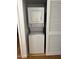 Efficient laundry room featuring a stacked washer and dryer and louvered doors at 520 N Stapley Dr # 265, Mesa, AZ 85203