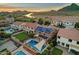 Aerial view of a desert home community with canal, with pools, solar panels, and scenic mountain views at 5223 W Bent Tree Dr, Phoenix, AZ 85083