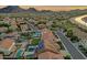 Stunning aerial shot highlighting a community with pools and solar panels, set against a picturesque mountain backdrop at 5223 W Bent Tree Dr, Phoenix, AZ 85083