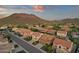 Expansive aerial view showcasing homes with desert landscaping in a vibrant community with stunning mountain views at 5223 W Bent Tree Dr, Phoenix, AZ 85083