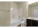 Clean bathroom featuring a tub and shower combo, tile floors, and dark wood vanity at 5223 W Bent Tree Dr, Phoenix, AZ 85083
