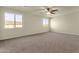 Large bedroom features plush carpet, neutral walls, a ceiling fan and sun-filled windows at 5223 W Bent Tree Dr, Phoenix, AZ 85083