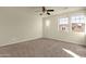 Large bedroom with neutral walls, carpeted floors, and large windows for natural light at 5223 W Bent Tree Dr, Phoenix, AZ 85083