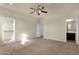 Spacious bedroom features neutral walls, carpet, ceiling fan and an attached bathroom and walk-in closet at 5223 W Bent Tree Dr, Phoenix, AZ 85083