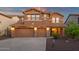 Charming two-story home featuring a three-car garage and beautiful stone accents with inviting landscape at 5223 W Bent Tree Dr, Phoenix, AZ 85083
