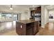 Open-concept kitchen island with seating area and dark wood cabinetry with stainless steel appliances at 5223 W Bent Tree Dr, Phoenix, AZ 85083