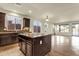 Open kitchen featuring granite countertops, dark cabinetry, an island and plenty of lighting at 5223 W Bent Tree Dr, Phoenix, AZ 85083