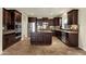 Well-equipped kitchen with stainless steel appliances, granite countertops and dark wood cabinets at 5223 W Bent Tree Dr, Phoenix, AZ 85083