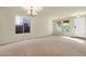 Large, airy living room featuring plush carpet and multiple windows for ample natural light at 5223 W Bent Tree Dr, Phoenix, AZ 85083