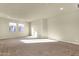 Large living room featuring neutral walls and carpet flooring with two windows at 5223 W Bent Tree Dr, Phoenix, AZ 85083