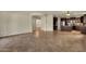 Open-concept living room with tile flooring seamlessly connecting the living space and kitchen area at 5223 W Bent Tree Dr, Phoenix, AZ 85083