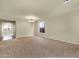 Spacious carpeted living room with natural light and chandelier, ideal for entertaining at 5223 W Bent Tree Dr, Phoenix, AZ 85083