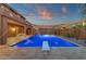 A luxurious pool with travertine decking, a diving board, and landscaping offers a serene outdoor retreat at 5223 W Bent Tree Dr, Phoenix, AZ 85083