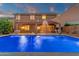 Inviting backyard pool with fountains, covered patio, and lush landscaping perfect for outdoor entertaining and relaxation at 5223 W Bent Tree Dr, Phoenix, AZ 85083