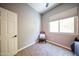 Cozy bedroom offers neutral walls, carpeting, and a large window at 5416 W Village Dr, Glendale, AZ 85308
