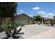 Well-maintained single-Gathering home featuring a three-car garage, mature trees, and easy-care desert landscaping at 5416 W Village Dr, Glendale, AZ 85308