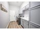 Well-lit laundry room with machines, cabinets, white countertops and a view to the exterior at 5416 W Village Dr, Glendale, AZ 85308