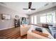 Bright living room with hardwood floors, ceiling fan, and comfortable seating arrangement at 5416 W Village Dr, Glendale, AZ 85308