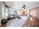 Bright living room with hardwood floors, ceiling fan, and comfortable seating arrangement at 5416 W Village Dr, Glendale, AZ 85308