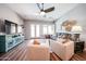 Bright living room with hardwood floors, ceiling fan, and comfortable seating arrangement at 5416 W Village Dr, Glendale, AZ 85308