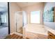 This en-suite bathroom offers both a glass enclosed shower and a soaking tub at 5416 W Village Dr, Glendale, AZ 85308