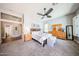 A cozy main bedroom offers an overhead fan, neutral decor, and an en-suite bath at 5416 W Village Dr, Glendale, AZ 85308