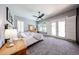 Spacious primary bedroom with carpet, ceiling fan, and an abundance of natural light at 5416 W Village Dr, Glendale, AZ 85308