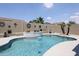 Beautiful backyard pool featuring a stunning waterfall, enhancing the outdoor living experience with a calming water feature at 5416 W Village Dr, Glendale, AZ 85308