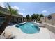 Gorgeous backyard oasis featuring a freeform pool with waterfall, seamlessly integrated with comfortable outdoor living spaces at 5416 W Village Dr, Glendale, AZ 85308