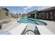 Inviting backyard showcasing a pool with a waterfall, complemented by lounge seating for outdoor relaxation and entertainment at 5416 W Village Dr, Glendale, AZ 85308