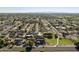 Aerial shot displaying a neighborhood with single-Gathering homes bordering a community park, enhanced by mountain views at 5602 N 73Rd Ave, Glendale, AZ 85303