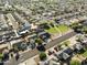 Aerial neighborhood view shows a green park, mature trees, and single-story homes lining the streets in a quiet community at 5602 N 73Rd Ave, Glendale, AZ 85303