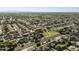 Aerial view of a well-planned community featuring tree-lined streets, a green park, and mountain views in the distance at 5602 N 73Rd Ave, Glendale, AZ 85303