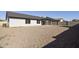 Large backyard with a gravel ground cover, patio, and block fence at 5602 N 73Rd Ave, Glendale, AZ 85303