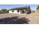 Gravel backyard featuring a covered patio and gray exterior and privacy fence at 5602 N 73Rd Ave, Glendale, AZ 85303