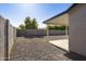 Gravel-covered backyard with a covered patio and block fence provides privacy at 5602 N 73Rd Ave, Glendale, AZ 85303