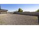 Wide shot of the expansive backyard with low maintenance gravel and tall privacy fence at 5602 N 73Rd Ave, Glendale, AZ 85303
