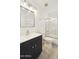 Bathroom with modern vanity, decorative mirror, shower-tub, and updated fixtures at 5602 N 73Rd Ave, Glendale, AZ 85303