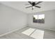 Sunlit bedroom with sleek ceiling fan and neutral walls at 5602 N 73Rd Ave, Glendale, AZ 85303