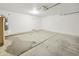 Spacious garage featuring bare concrete flooring and door to the house at 5602 N 73Rd Ave, Glendale, AZ 85303