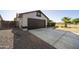 Attached two-car garage with a concrete driveway and desert landscaping at 5602 N 73Rd Ave, Glendale, AZ 85303