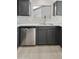 This kitchen features gray cabinetry, stainless steel appliances and a window for natural light at 5602 N 73Rd Ave, Glendale, AZ 85303