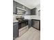 Modern kitchen with stainless steel appliances, granite countertops, and gray cabinets at 5602 N 73Rd Ave, Glendale, AZ 85303