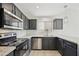 Charming kitchen with stainless steel appliances, gray cabinets, and speckled granite countertops at 5602 N 73Rd Ave, Glendale, AZ 85303