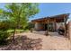 The backyard showcases a desert landscape, a patio with a pergola, and mature trees at 5659 N 195Th Dr, Litchfield Park, AZ 85340
