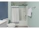 Well-maintained bathroom includes a shower-tub combo and white fixtures with a blue and green color scheme at 5659 N 195Th Dr, Litchfield Park, AZ 85340