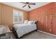 Comfortable bedroom featuring custom accent wall, plush carpet, shutters, and a ceiling fan at 5659 N 195Th Dr, Litchfield Park, AZ 85340
