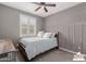 Cozy bedroom with a full bed, neutral paint, carpet flooring, ceiling fan, and a window with backyard view at 5659 N 195Th Dr, Litchfield Park, AZ 85340