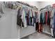 Walk-in closet features racks and shelves for organization and storage at 5659 N 195Th Dr, Litchfield Park, AZ 85340