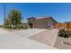 Attractive home featuring a wide driveway, desert landscaping, and a two-car garage at 5659 N 195Th Dr, Litchfield Park, AZ 85340